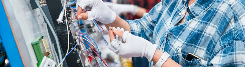 Young woman affixing cables into electrical applications