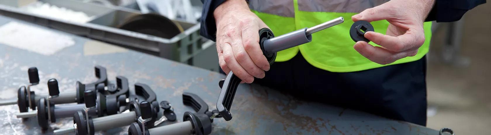 Worker installing industrial handles in a production area