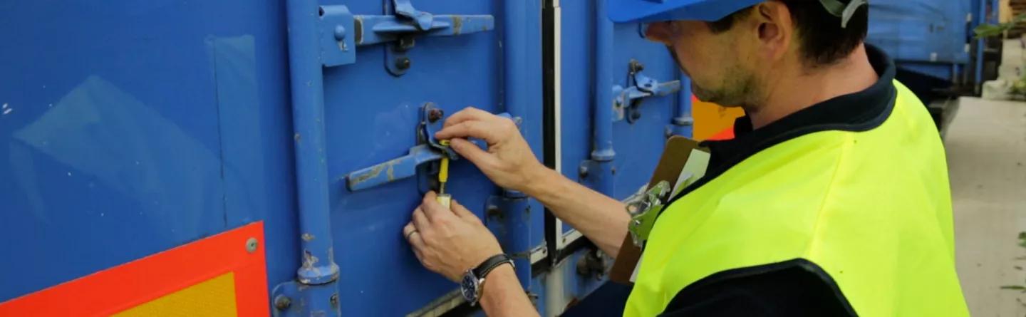 Worker securing seal to lorry