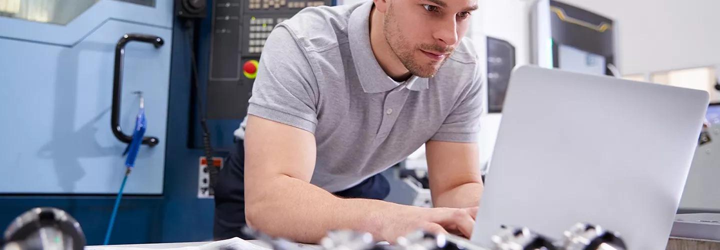 Man leaning forward looking at laptop