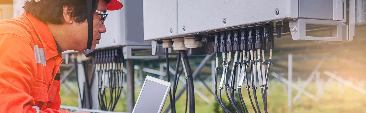 Engineer with cables in solar panel fixings