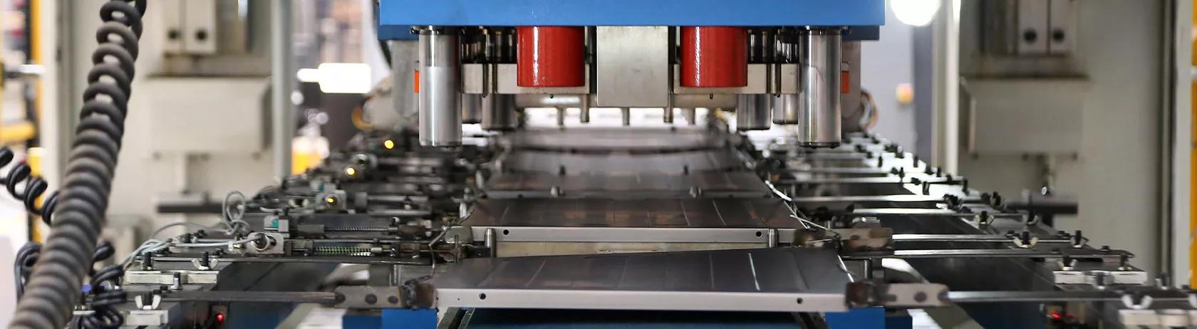 Panels from an electrical household appliance on a production line