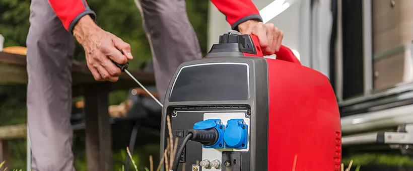 man starting an inverter generator by hand