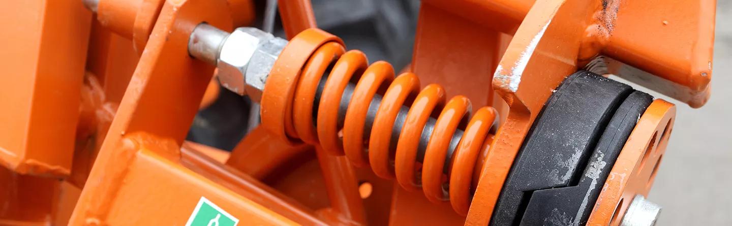Torsion spring in agricultural machinery