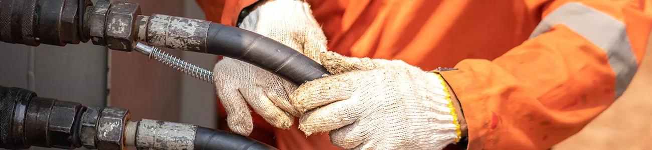 Engineer holding spiral wrapped hose