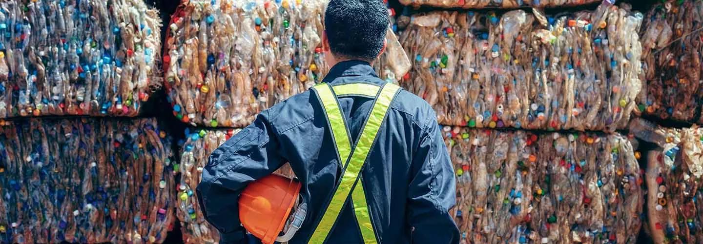 Person with back turned to camera looking at bags of plastic