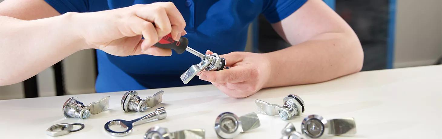 Woman screwing together locks and latches