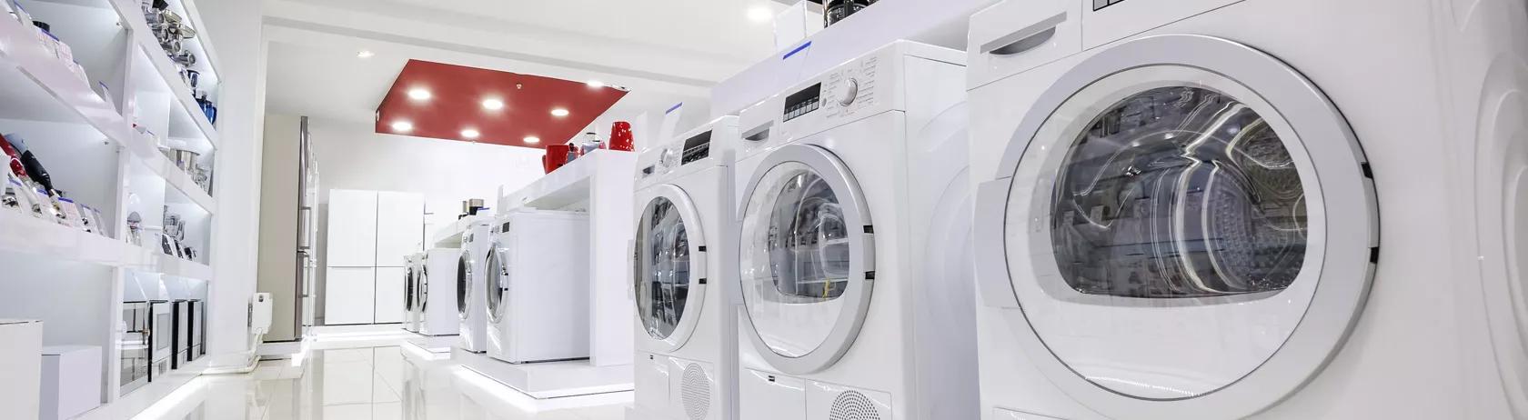 Rows of home appliances and washing machines in a retail store