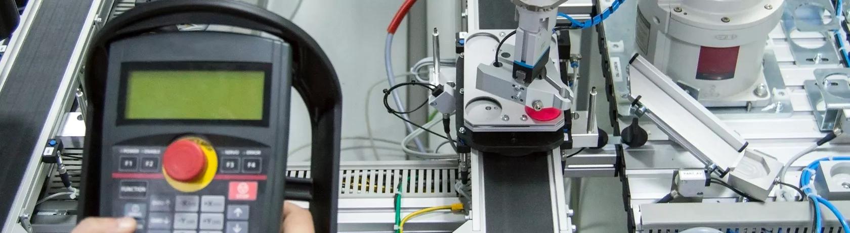 Man holding a control panel in a smart factory