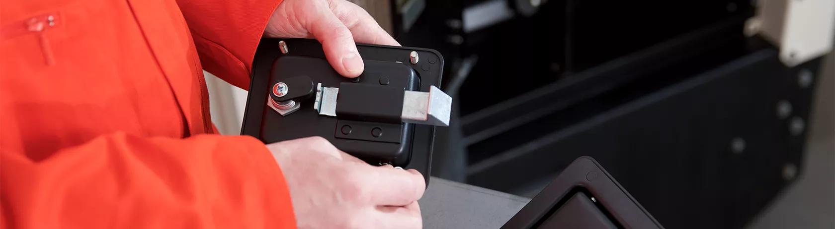 Engineer adjusting some cabinet latch hardware