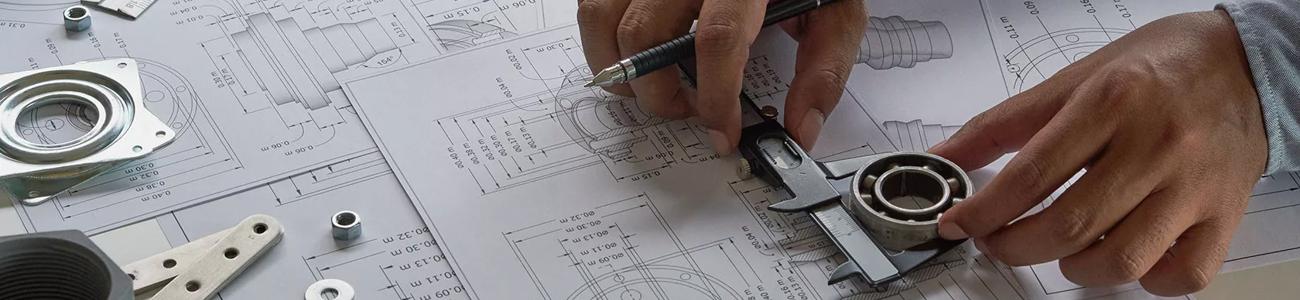 a designer looking at a mechanical drawing 