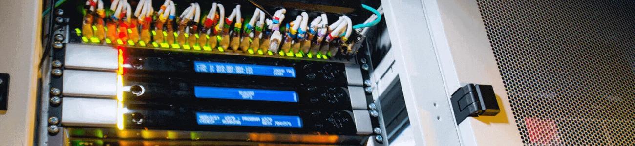 Engineer checking servers in a data cabinet