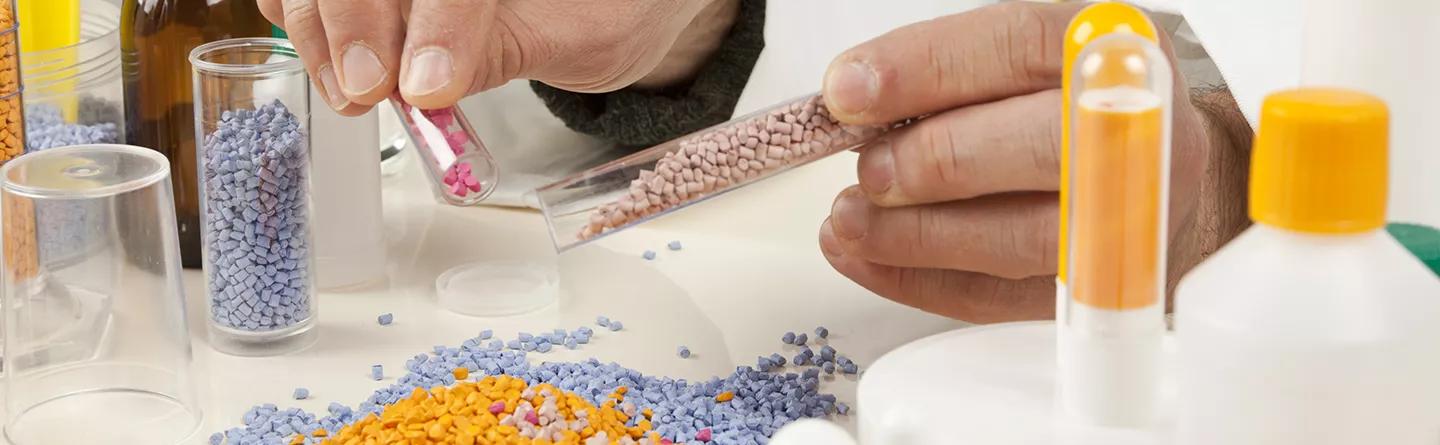 Technician working with plastic granules