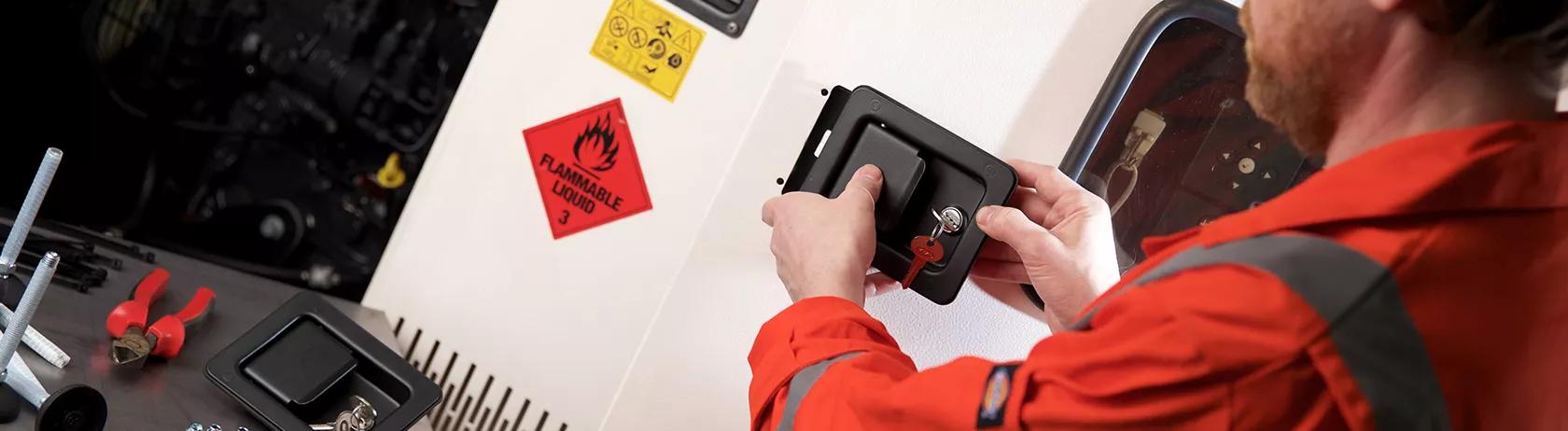 Engineer inspecting an industrial door latch ready for installation on a generator