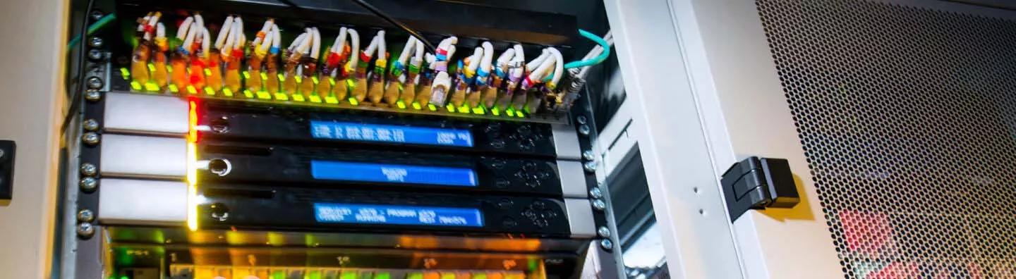 Engineer checking servers in a data cabinet