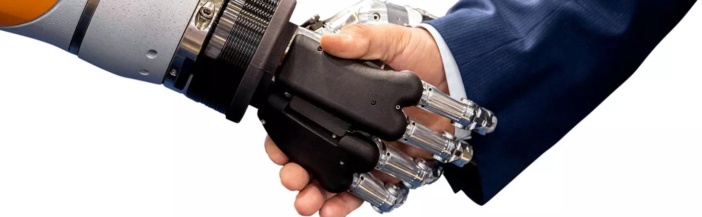 Business man shaking humanoid cobot hand