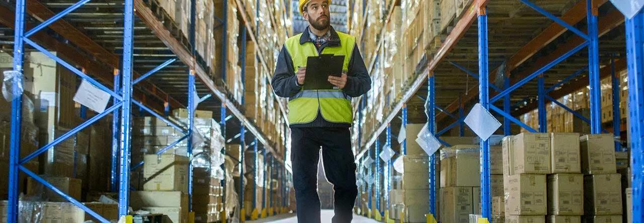 Man in hard hat walking through warehouse