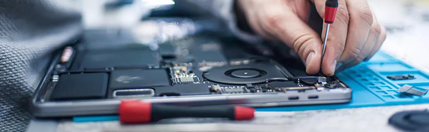 Engineer using screw driver on electronics