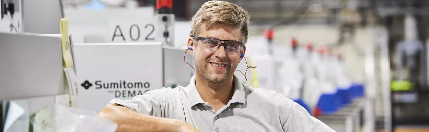 Man in factory wearing earplugs