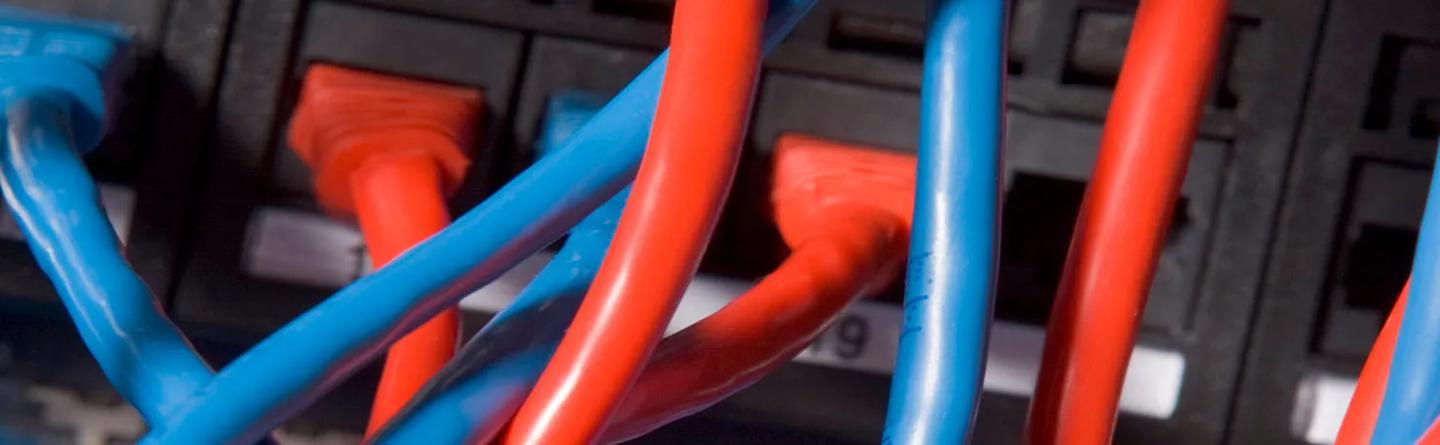 Red and blue cables in need of a cable management solution