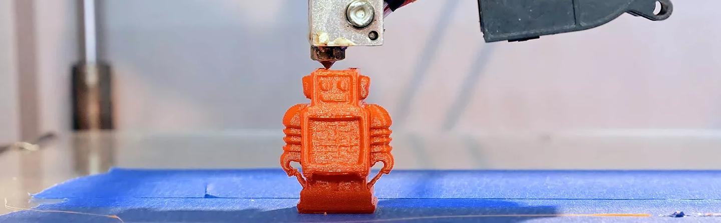 A small plastic robot: an example of products produced by 3D printing or Dip moulding. 