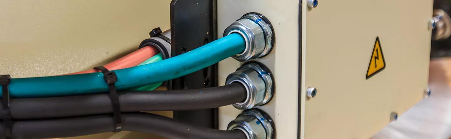 Protective metal cable glands on electrical cabinet