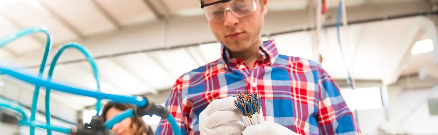 Man in lab examining cable protection