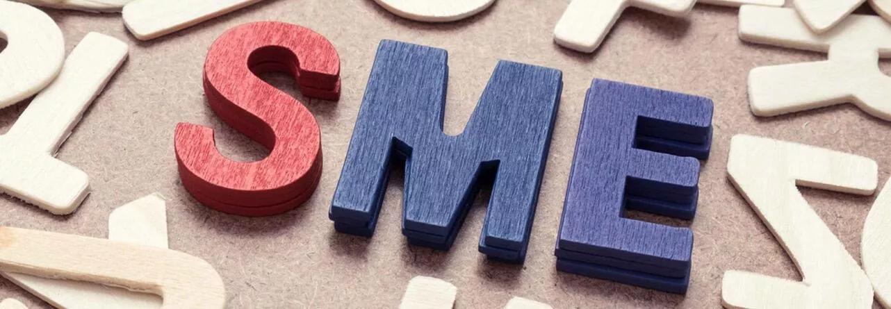 Wooden coloured letters spelling SME